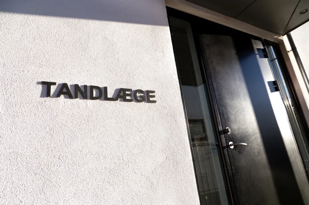 Skilt med teksten TANDLÆGE ved klinikkens indgang